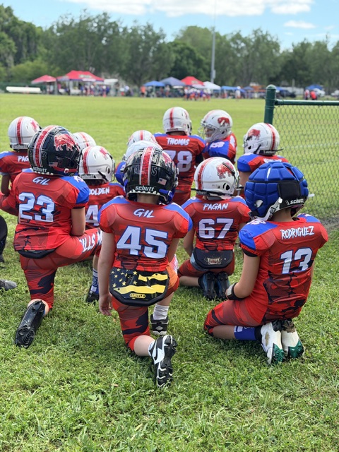 Keystone Bills 8U squad kneeling together before kickoff