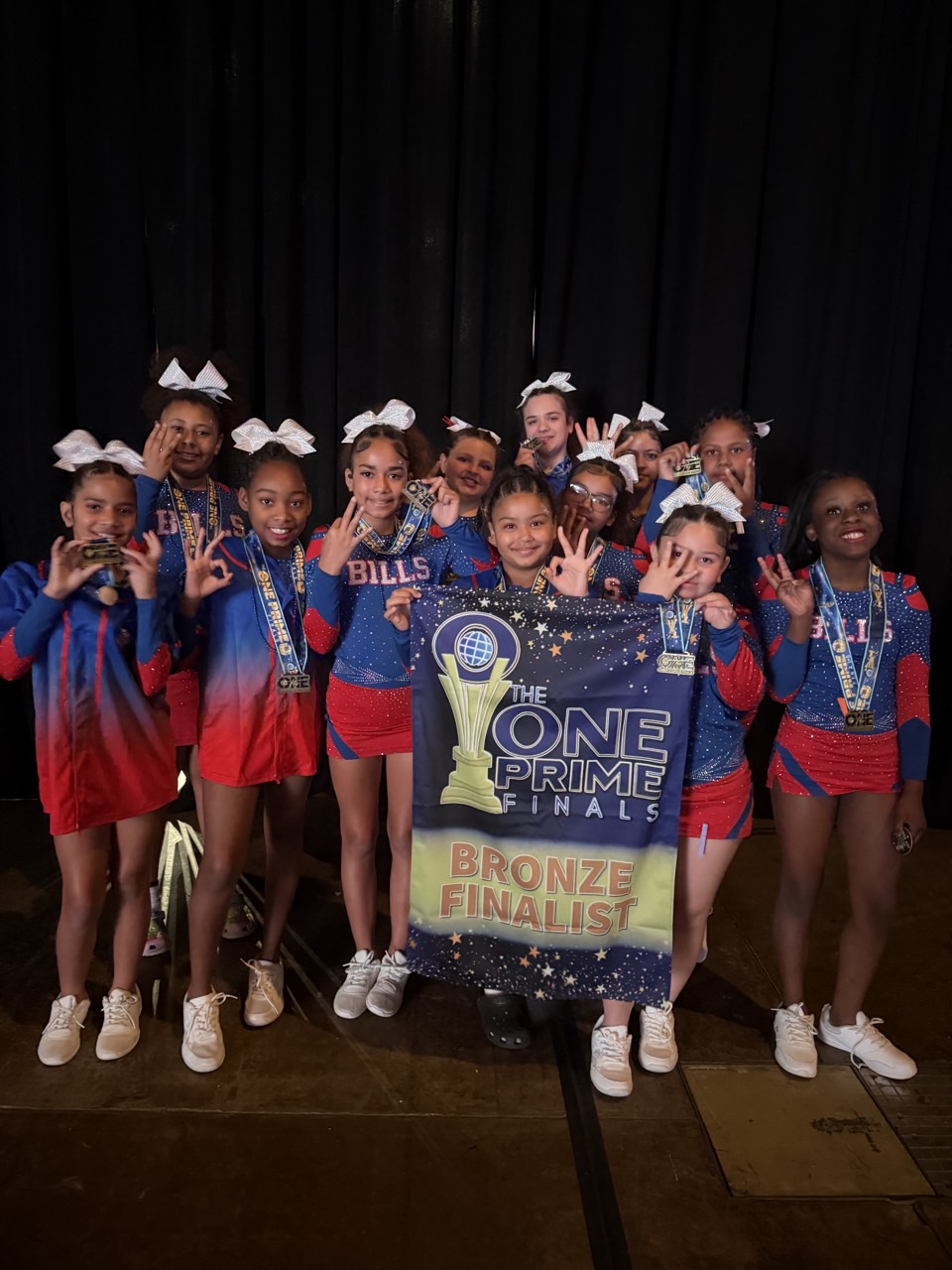 Dynamite Divas holding Bronze Finalist banner at One Prime Finals nationals